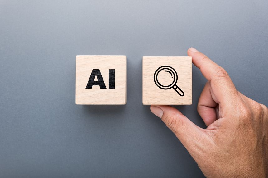 Hand holding wooden block with magnifying glass icon next to AI block represents artificial intelligence used for fact checking, verifying information, and data research