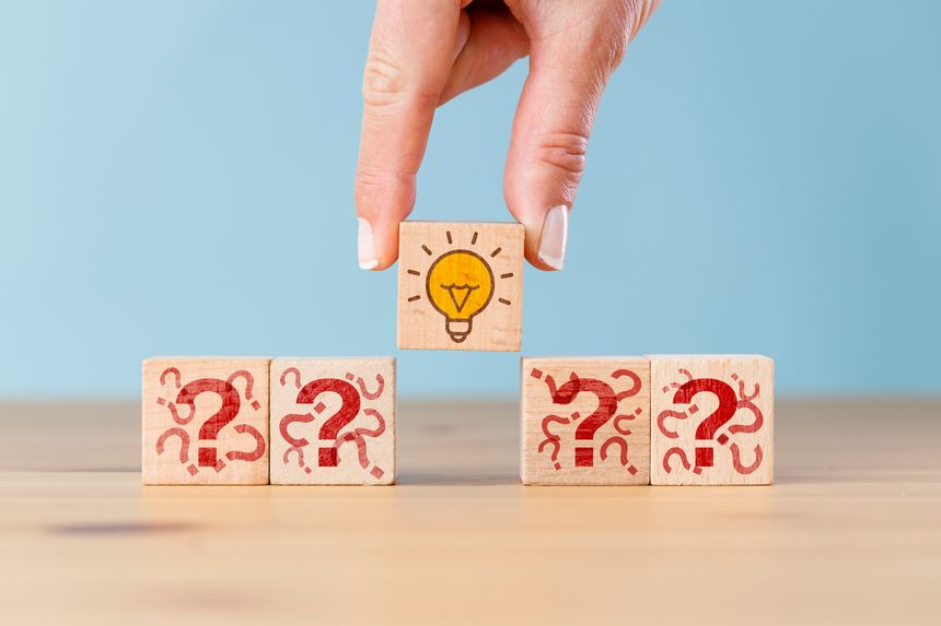 Concept creative idea, solution and innovation. Hand picked wooden cube block with light bulb icon