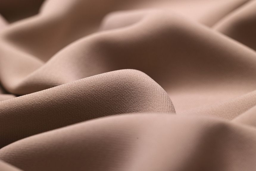 Close-up of delicate, lightweight georgette fabric, showcasing its soft, flowy texture and subtle drape, perfect for fashion, textiles, and design projects.