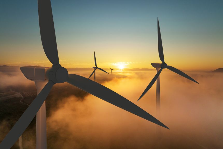 Wind turbine silhouette at sunrise, wind energy and nature concept.