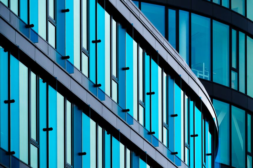 Modern Glass Office Building with Blue-Tinted Windows and Sleek Architectural Design, modern office building