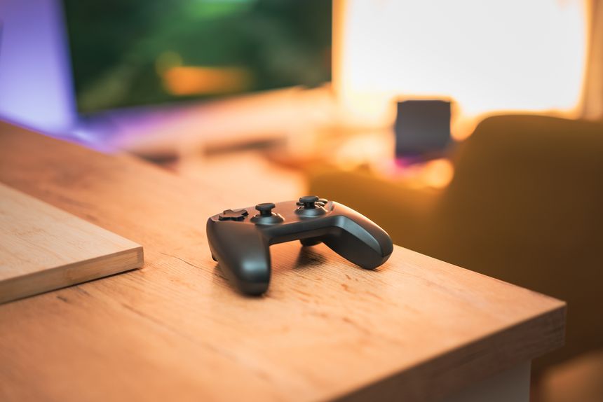 video game pad living room interior conole tv screen in background