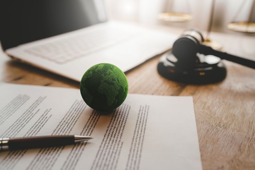 Green Earth with a judge's gavel symbolizes environmental law, sustainability, global responsibility, climate policy, and legal protection
