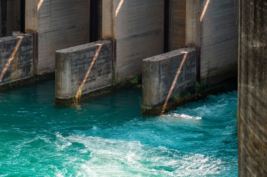 Concrete regulator channels turquoise water for irrigation and hydropower generation