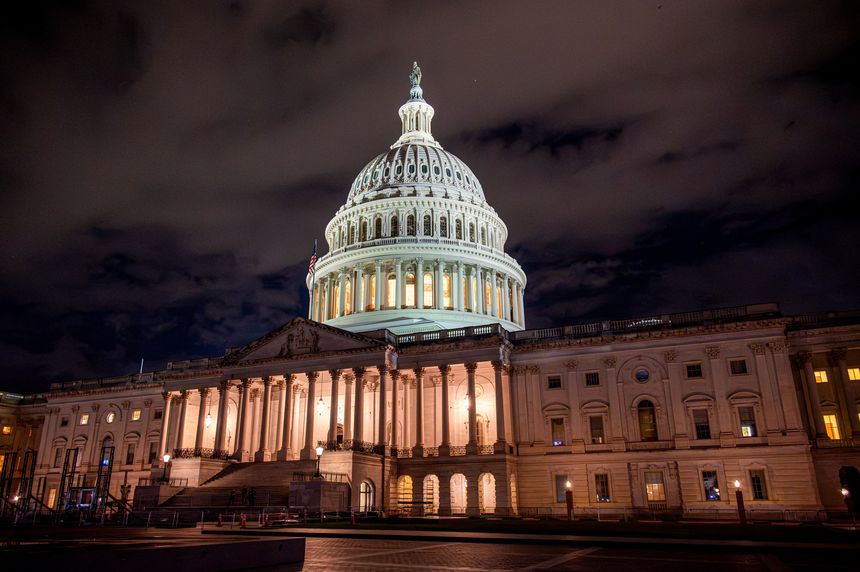 The United States Capitol building in Washington DC illuminated at night