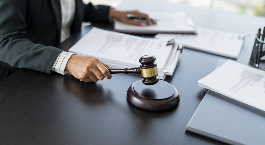 Lawyer businessman working with lawbook in office or courtroom Legal counsel with gavel and legal law. justice and lawyer concept Judge gavel hammer on Lawyer desk