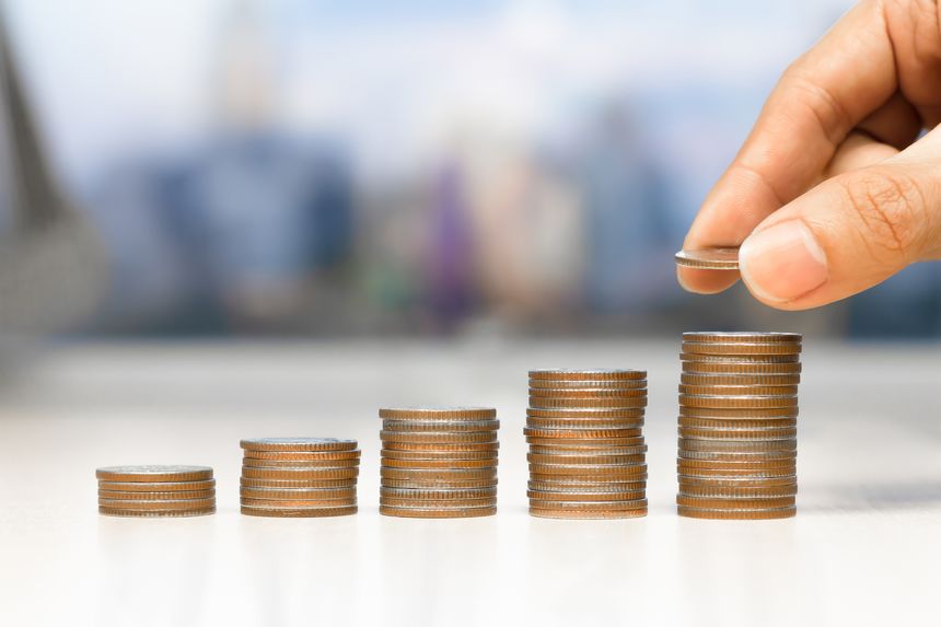 Saving money concept preset by Male hand putting money coin stack growing business - Business investment and saving money concept.