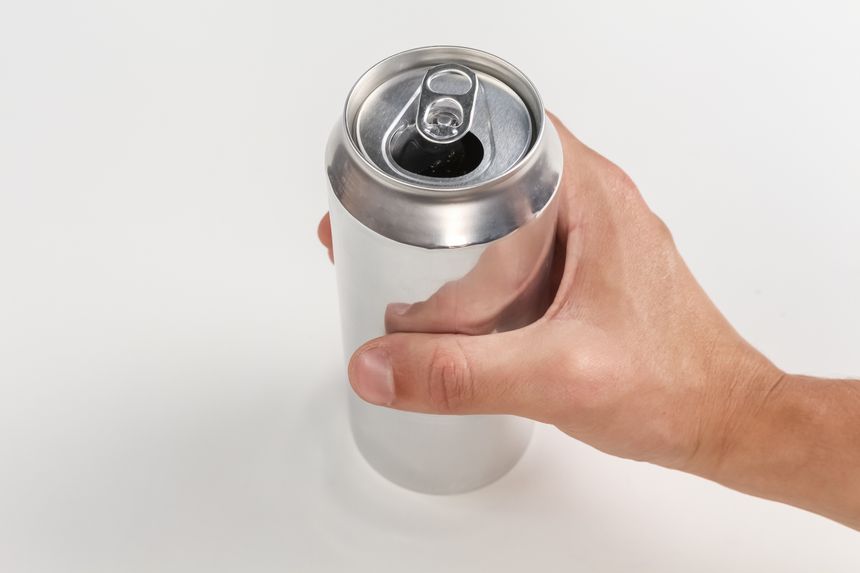 Hand holding an aluminum one isolated over a white background, viewed from above.