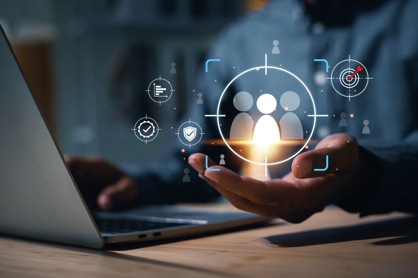 Businessman uses a laptop to target and select key personnel (Talent Acquisition) using digital technology. The image conveys an HR strategy focused on finding the right employees to drive the organization towards future success and stability.