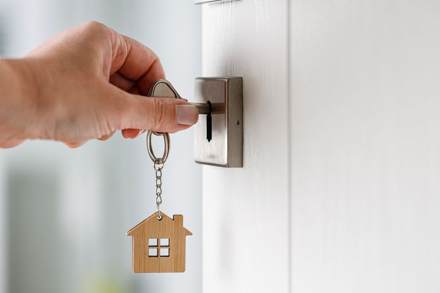 Woman hand opening a door with key