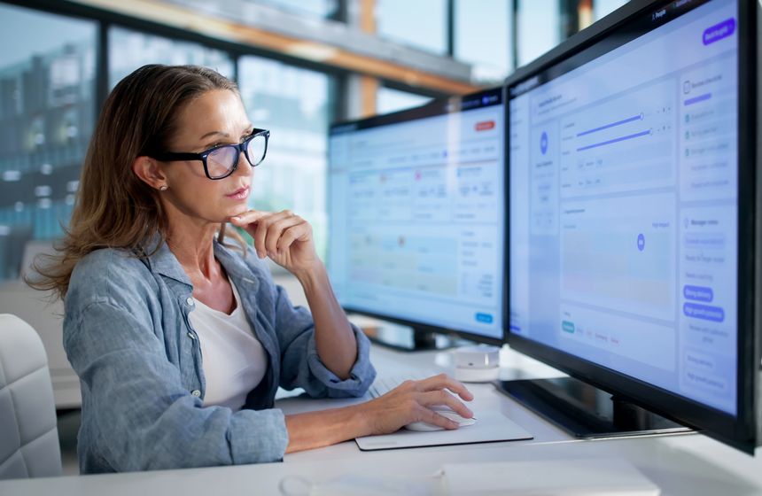 Human Resources Manager Analyzing Employee Performance Data Using Talent Software