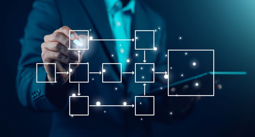 Businessman drawing virtual workflow diagram with connected boxes and arrows, digital process automation and business strategy concept, data flow management and technology innovation interface.