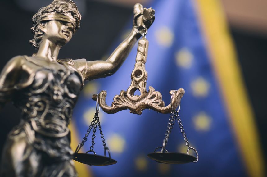 Law and Justice, Legality concept, Scales of Justice, Lady Justice in front of the European Union flag in the background.