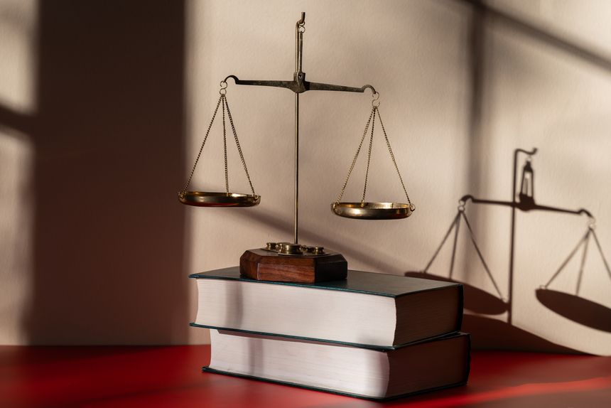 Scales of justice against a light and shadow background