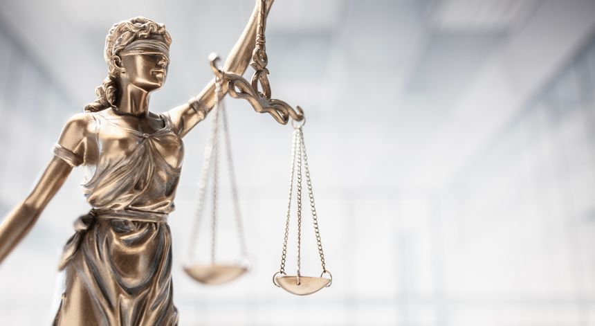 Legal and law concept statue of Lady Justice with scales of justice and office background