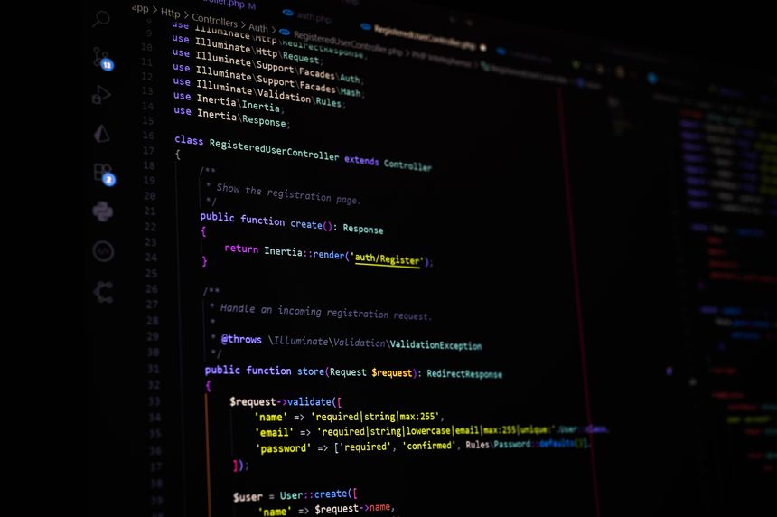 Close-up of a computer screen with Laravel PHP register controller using Inertia.js for authentication. Ideal for web development, backend systems, or coding tutorial concepts.