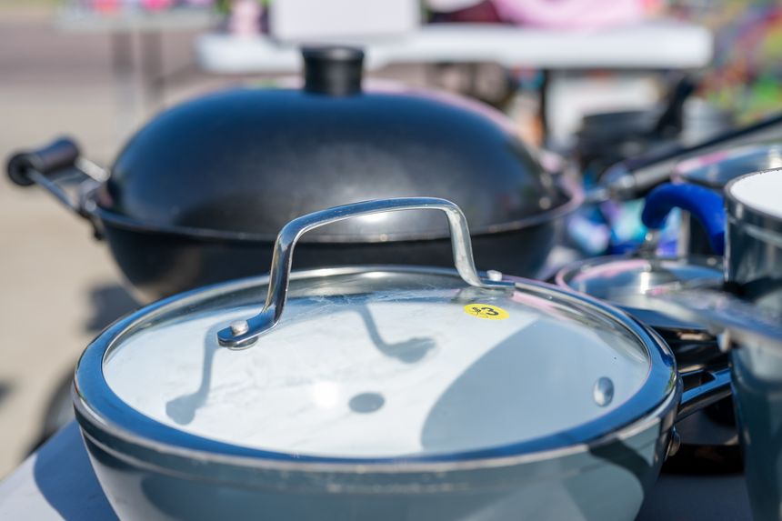 Row of second-hand pots and pans at a garage sale. High quality photo